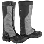 A pair of women's gaiters designed to cover the lower leg and footwear, primarily in black and gray colors with adjustable straps and a flexible piping design.